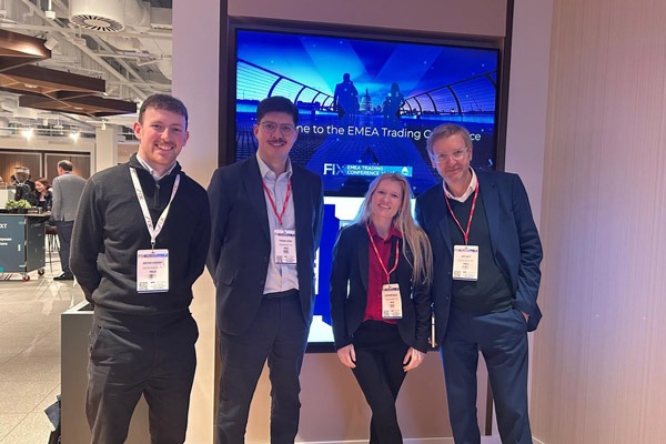 4 team members standing together at an event